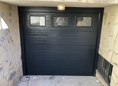 Puerta seccional con acabado en tonos oscuros y elegantes